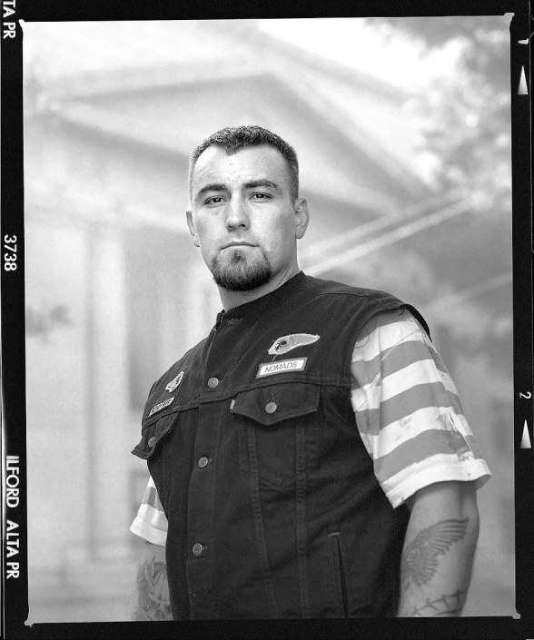 Editorial photography portrait of motorcycle club member with denim vest outside of Prescott Arizona Courthouse by Phoenix commercial photographer Jason Koster.