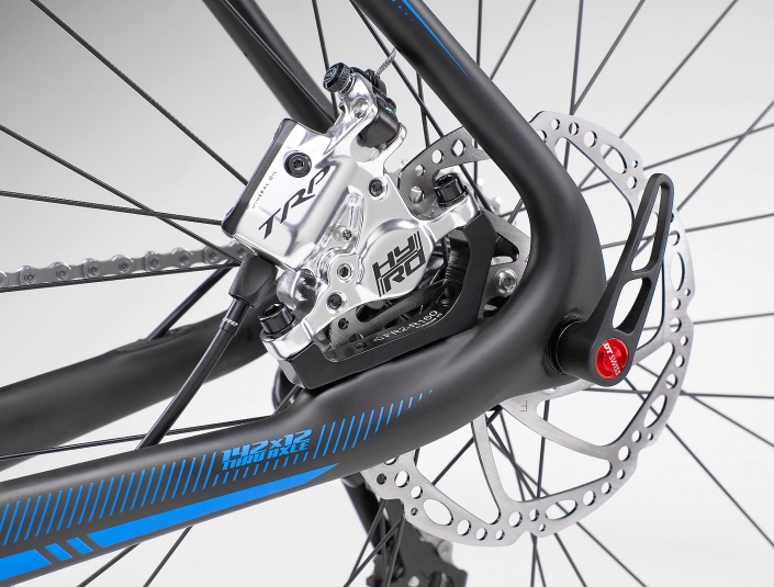 Product photography of Shimano TRP rear disc brakes and DT Swiss 142 x 12 Thru Axle on Pivot Cycles, Vault, CX bike.